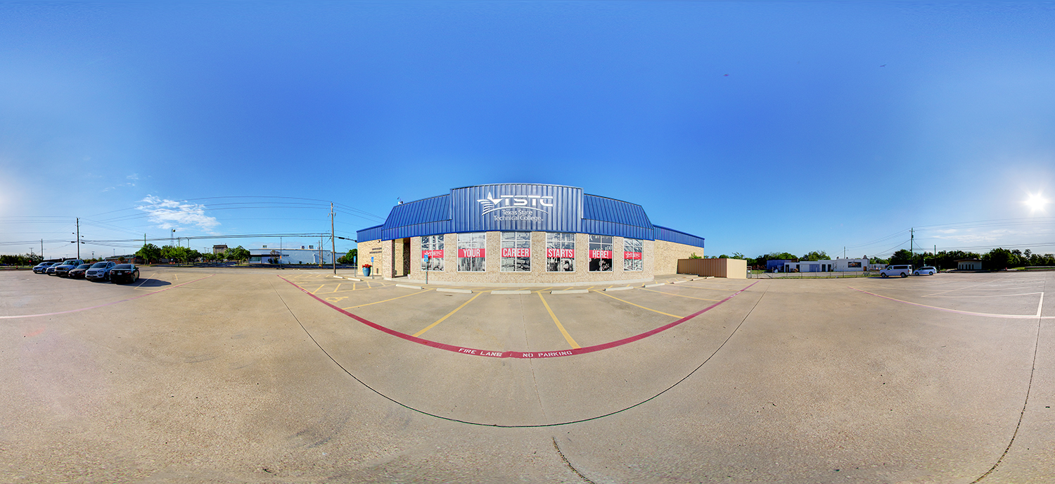 Panoramic view of a Texas State Technical College building with a blue metal roof and large front windows displaying “Your Career Starts Here,” surrounded by a wide parking lot under a clear blue sky.